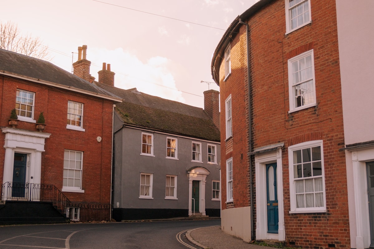 Residential street in England with terraced houses and front doors relating to bailiff enforcement visits